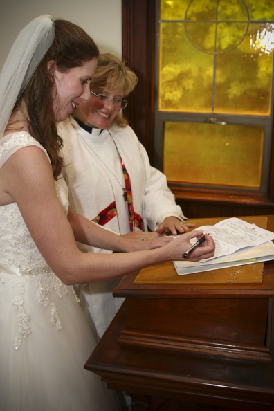 Betsy signs the marriage license